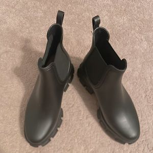 Matted black Jeffrey Campbell rain boots.